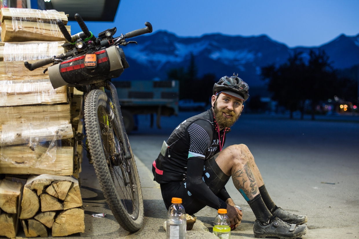 The Tour Divide - a happy rider enjoying a quick pitstop in Fernie in 2018