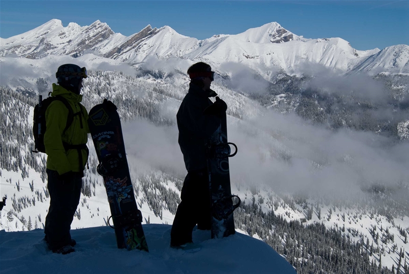 Snowboarders taking in the views at Island Lake Catskiing